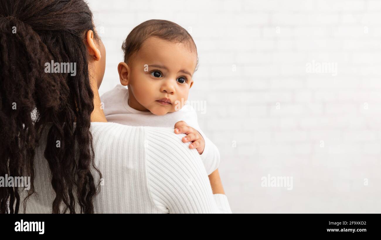 Mere Afro Americaine Posant Avec Bebe Mignon Sur Le Mur Gris Photo Stock Alamy