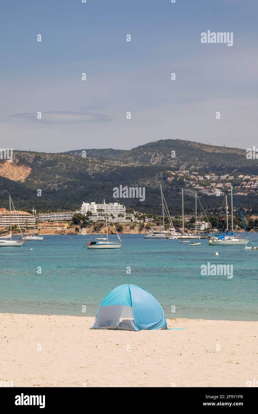 Palmanova, Majorque, Espagne. 20 avril 2021. Vue sur la plage d'une femme et d'une tente à vent en face de la mer et des bateaux à Pamanova à Majorque. Credit: John-Patrick Morarescu/ZUMA Wire/Alamy Live News Banque D'Images