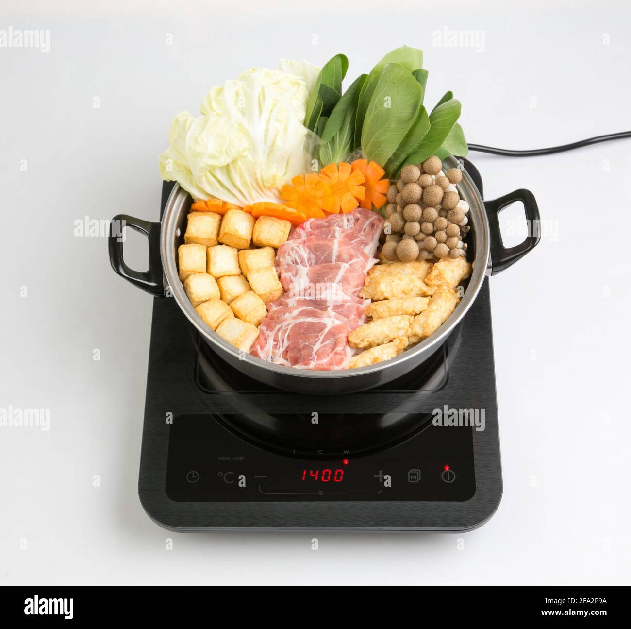 table de cuisson à induction avec pot sukiyaki isolé sur fond blanc Banque D'Images