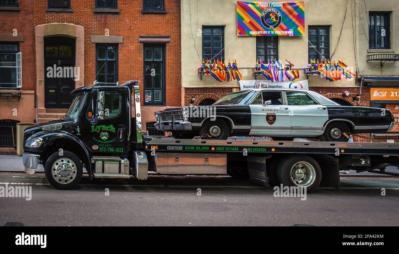 New York City, États-Unis, mai 2019, vue d'un vieux véhicule de police transporté sur un camion de remorquage par le Stonewall Inn une taverne dans le village de Greenwich Banque D'Images