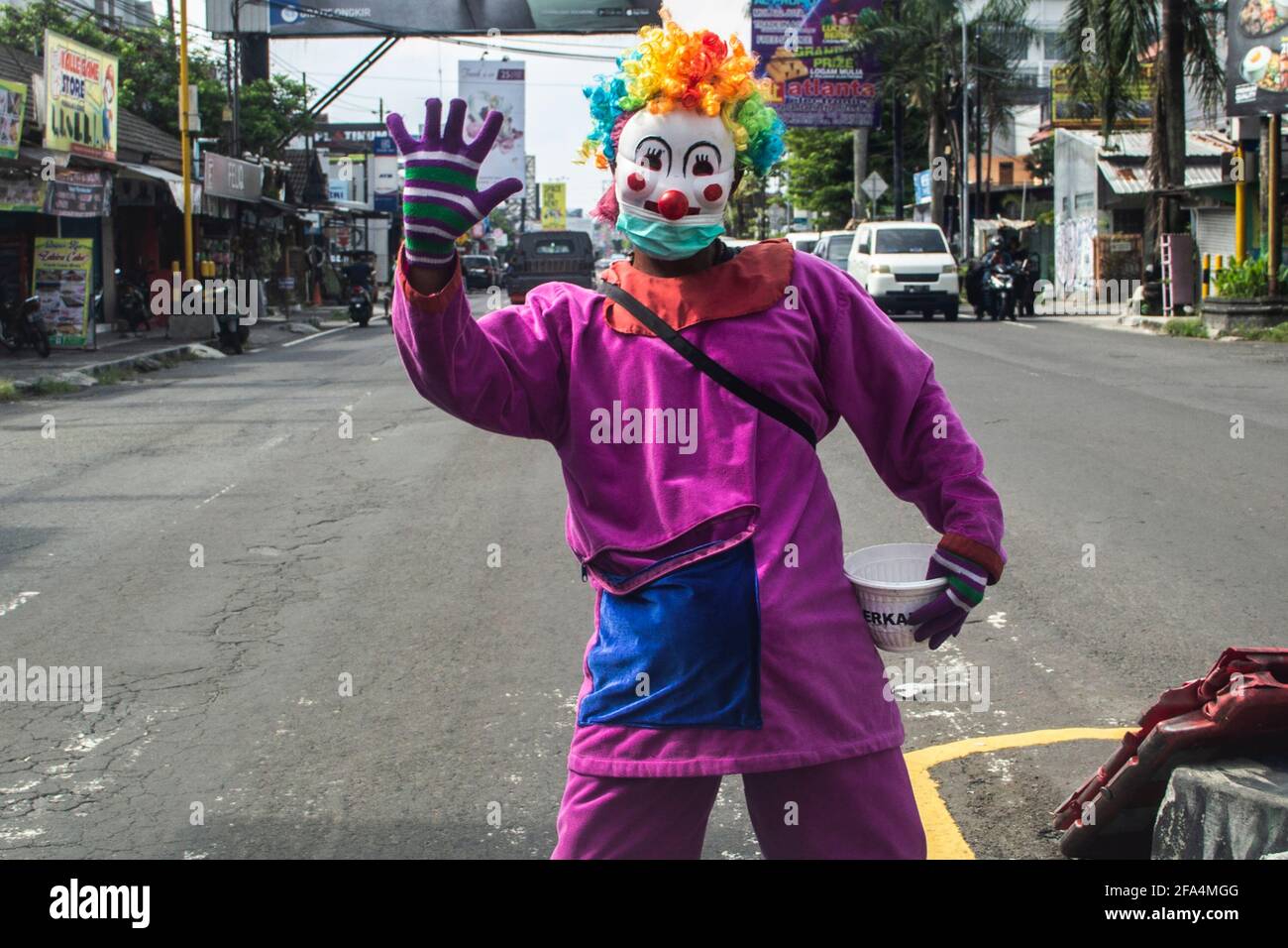 5 avril 2021, YOGYAKARTA, YOGYAKARTA, INDONÉSIE: Un mendiant portant un costume de clown et un masque pour éviter le virus corona à Yogyakarta, Indonésie. Sur la base des données du groupe de travail indonésien Covid-19, il a atteint 1.6 millions de cas, tandis que les dernières données mondiales de World mètres, le nombre de cas mondiaux Covid-19 le vendredi 23 avril 2021 matin à 08.00 WIB a atteint 145,304,364 cas. L'ajout de cas quotidiens était de 871,976, 12,935 sont morts. Le total guéri était de 123,571,344 et a laissé 18,649,006 cas actifs de Covid-19 dans le monde. Dans ces données, les États-Unis (É.-U.) sont toujours en première position en t Banque D'Images
