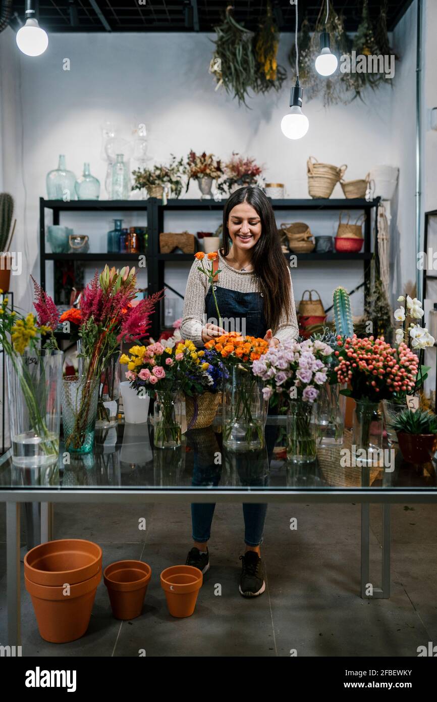 Fleuriste souriant travaillant au fleuriste Banque D'Images