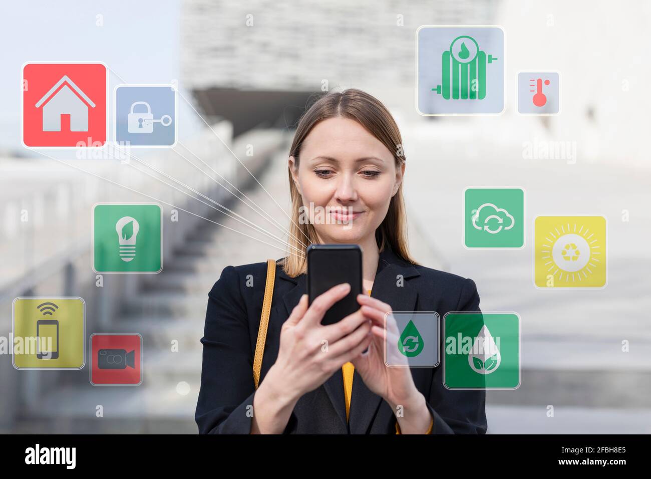 Femme entrepreneur utilisant un téléphone portable en se tenant près de l'ensemble d'icônes à l'extérieur Banque D'Images