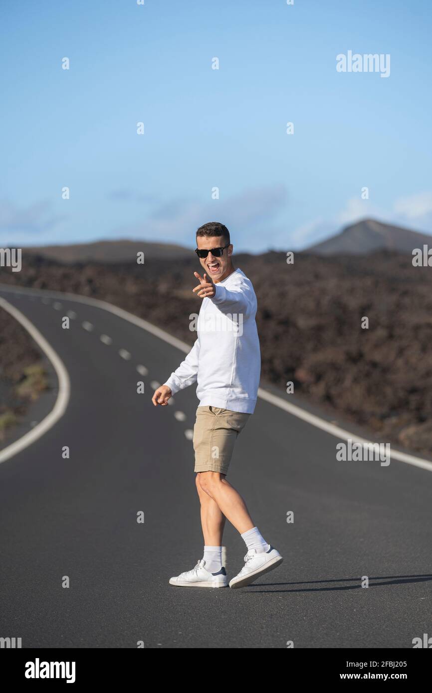 Joyeux touriste en se tenant debout sur la route Banque D'Images