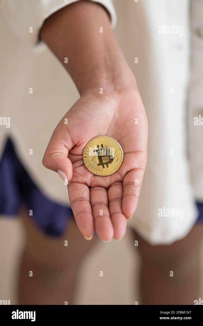 Crypto-monnaie dans la paume de la main de la femme Banque D'Images