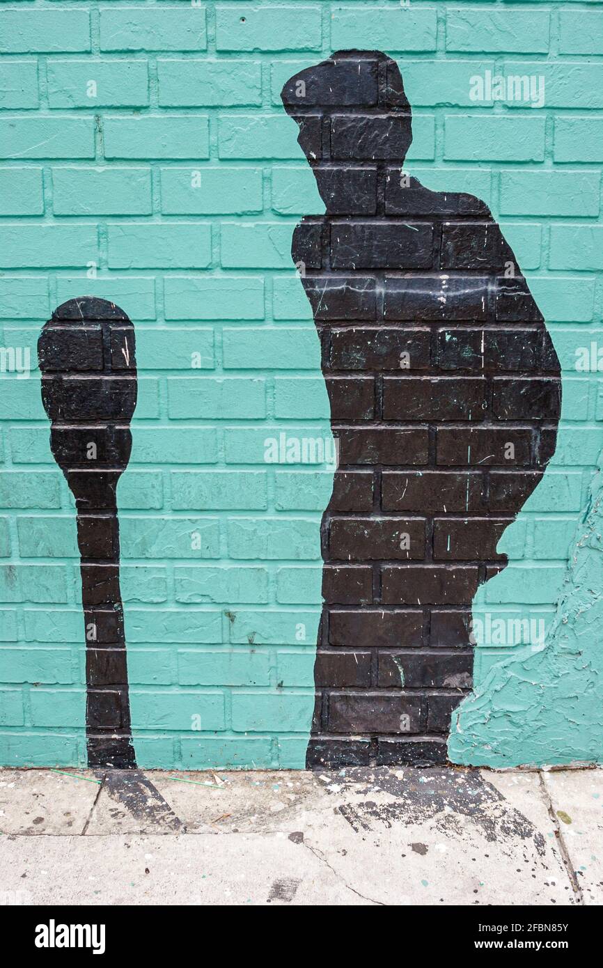 Miami Florida, Wynwood Midtown Arts District, peintures murales silhouette de stationnement meterman mâle ombre mur de briques, Banque D'Images
