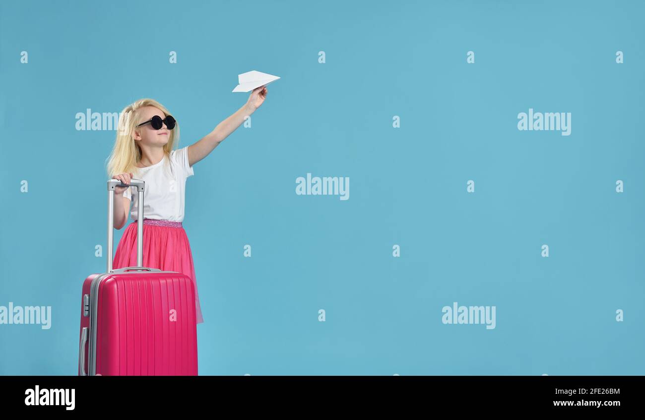 Une fille lance un avion en papier et l'attend voyage Banque D'Images