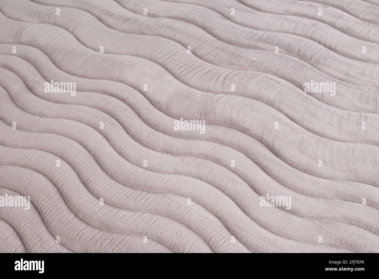 gros plan du motif sur le matelas gris, surface de texture comme arrière-plan Banque D'Images