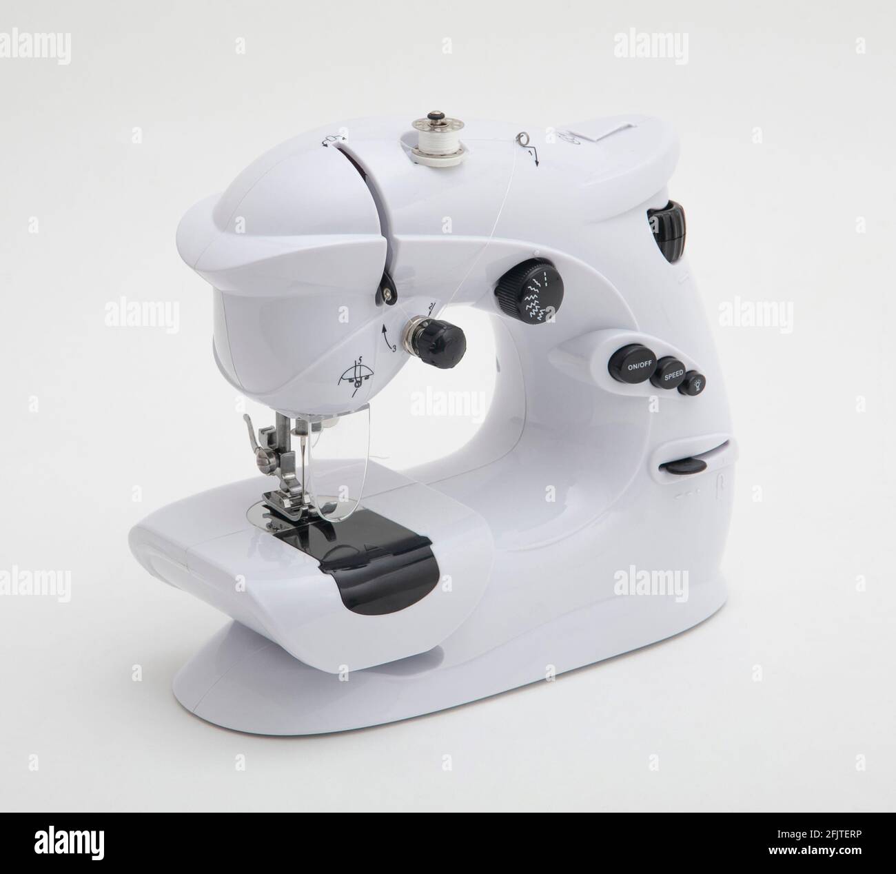 Petite machine à coudre isolée sur fond blanc Banque D'Images