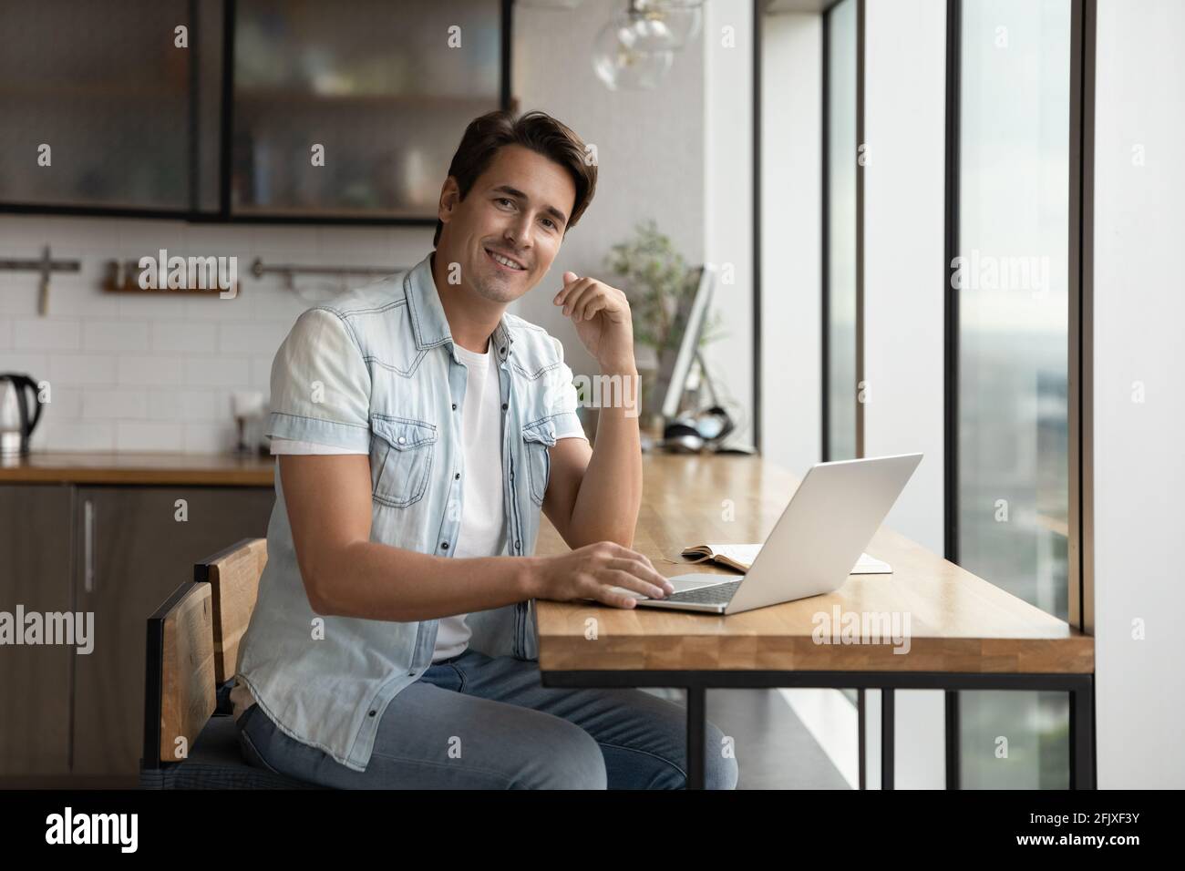 Portrait d'un homme souriant sur un ordinateur portable en ligne Banque D'Images