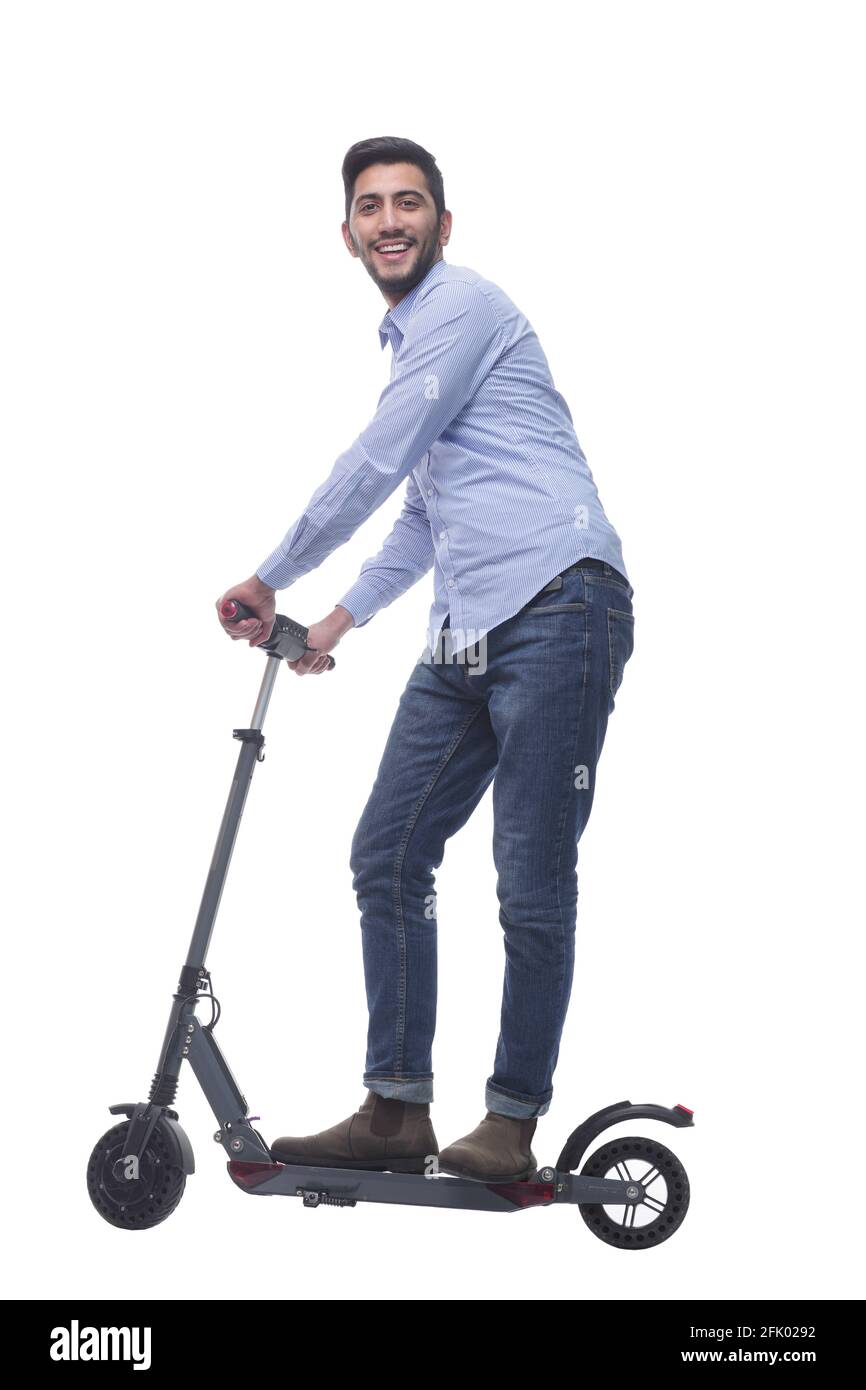 vue latérale. jeune homme attrayant avec un scooter électrique. Banque D'Images