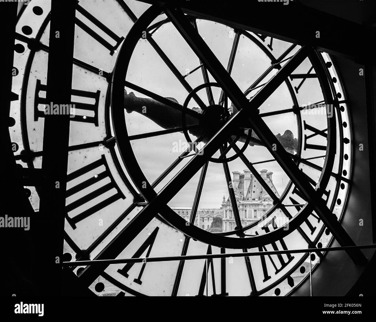 PARIS, FRANCE - 6 AVRIL 2014 : une horloge avec des chiffres romains dans le musée d'Orsay et la vue sur le musée du Louvre. Banque D'Images