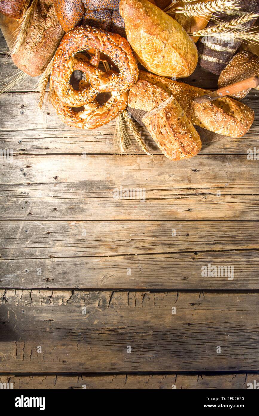 Assortiment de délicieux pains fraîchement sortis du four, sur fond de bois rustique copie espace Banque D'Images