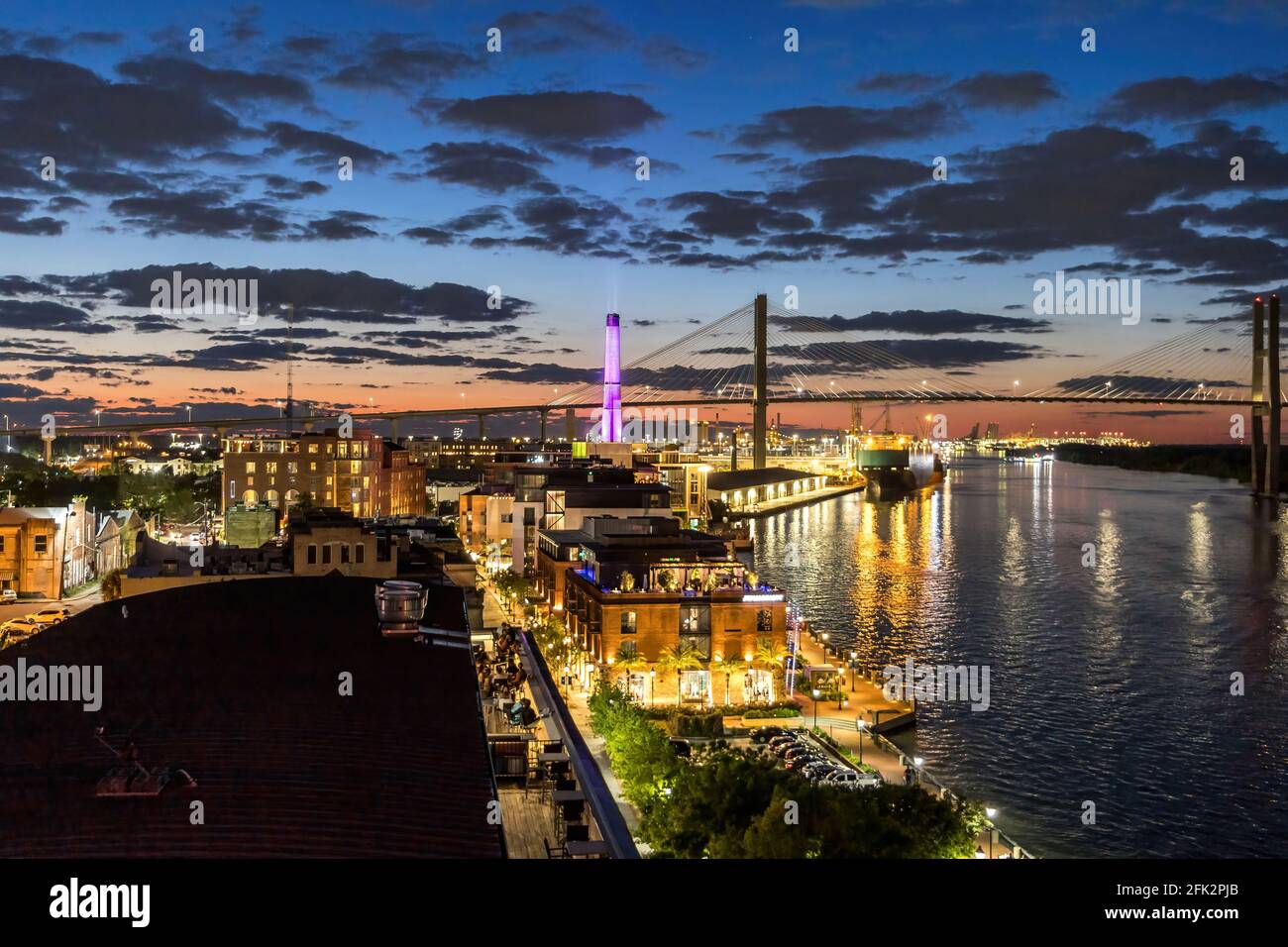 Savannah Georgia Skyline au coucher du soleil depuis le sommet d'une terrasse sur le toit avec l'eau de la rivière, le pont et les bâtiments Banque D'Images