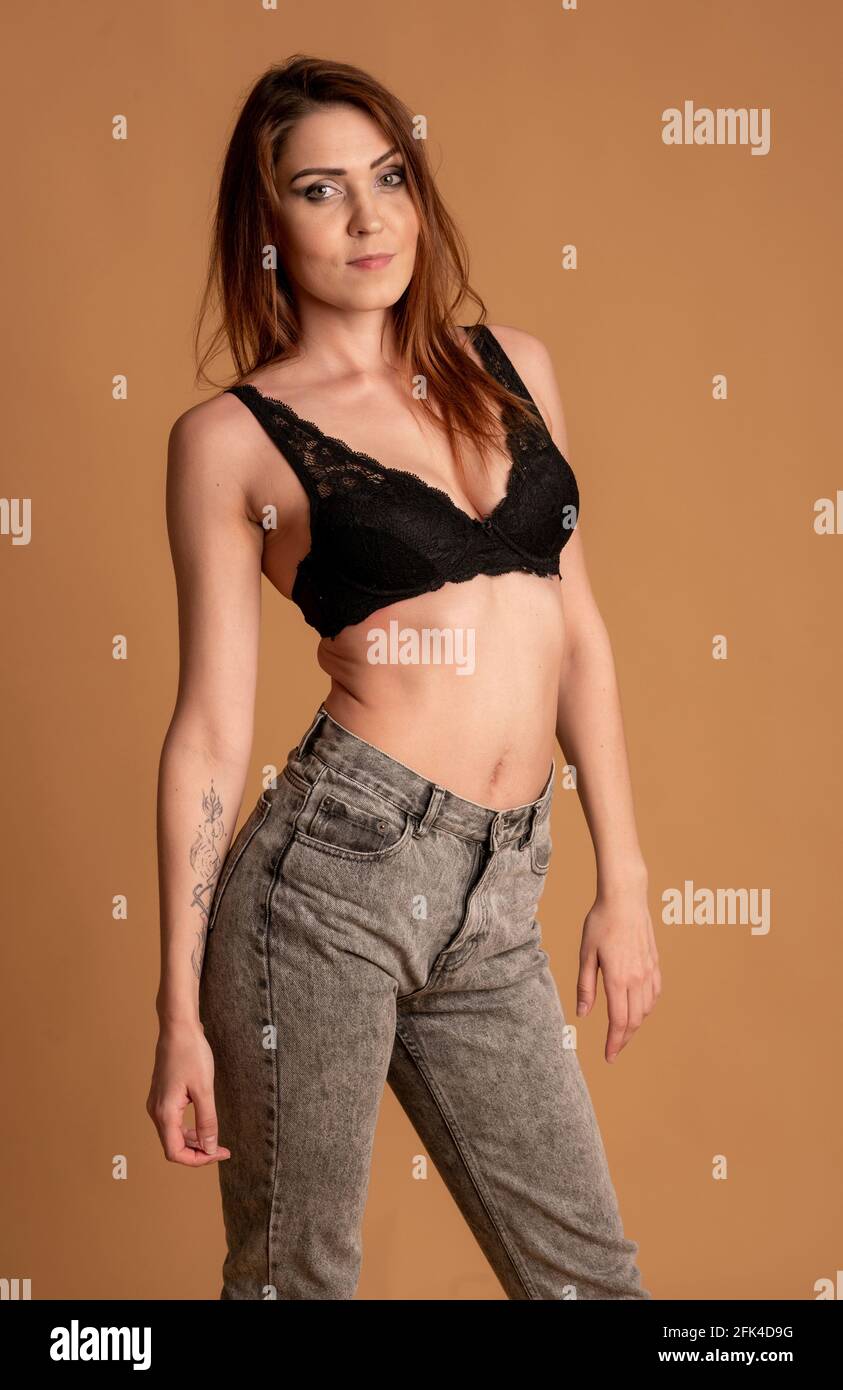 Belle femme en maillot de bain beige sur fond rose Banque D'Images