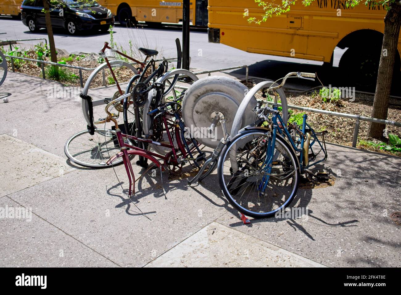 New York, NY, USA - 28 avril 2021 : bicyclettes déchirées attachées à un porte-vélos près de Cooper Union dans l'East Village de Manhattan Banque D'Images
