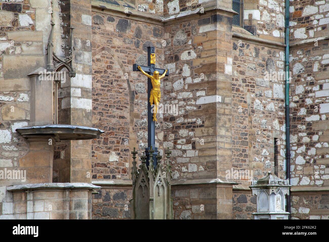 Croisez avec la crucifixion de Jésus-Christ contre le fond du mur d'un temple ancien. Banque D'Images