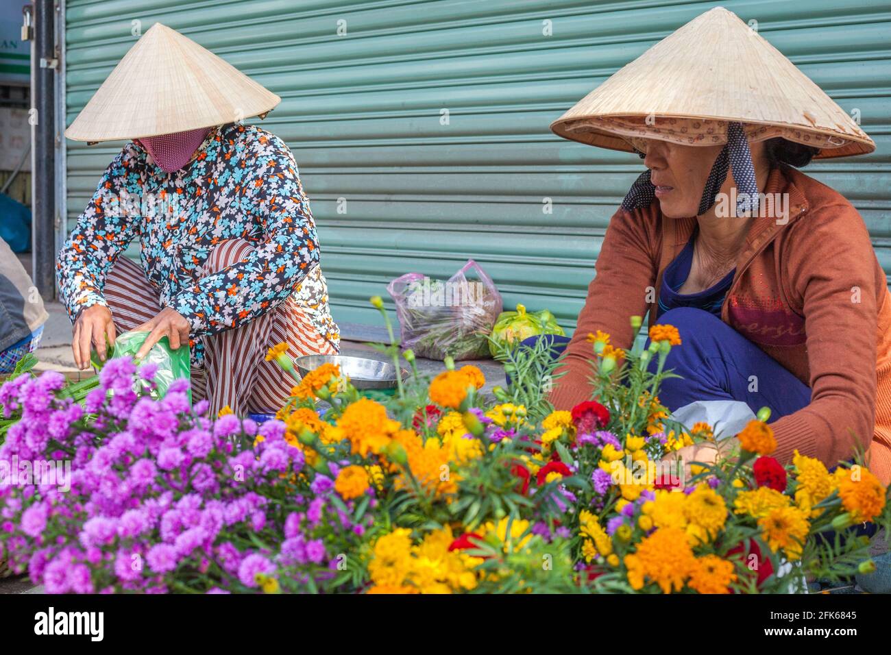 Deux femmes vietnamiennes vendant des fleurs sur le côté de la route, Hoi an, Vietnam Banque D'Images