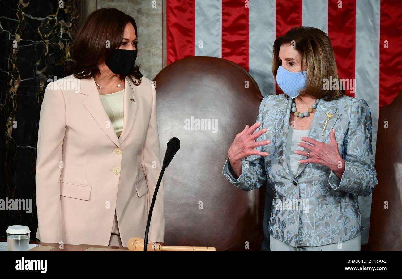 Washington, DC. 28 avril 2021. LE vice-président AMÉRICAIN Kamala Harris (L) s'entretient avec la Présidente de la Chambre des représentants américaine Nancy Pelosi (D-CA) avant le président américain Joe Biden lors d'une session conjointe du Congrès au Capitole des États-Unis à Washington, DC, le 28 avril 2021.Credit: Jim Watson/Pool via CNP | usage Worldwide Credit: actualités en direct de dpa/Alamy Banque D'Images