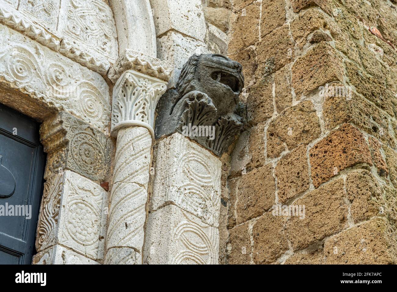 Détail de la capitale en forme de lion, portail d'entrée de la cathédrale des Saints Pierre et Paul à Sovana. Sovana, province de Grosseto, Toscane, Italie Banque D'Images