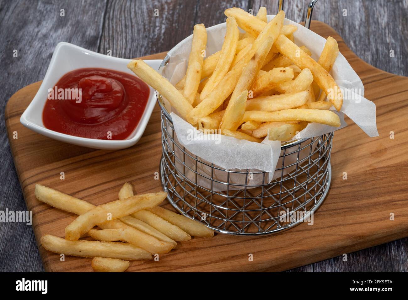 Un panier métallique de frites fines Banque D'Images