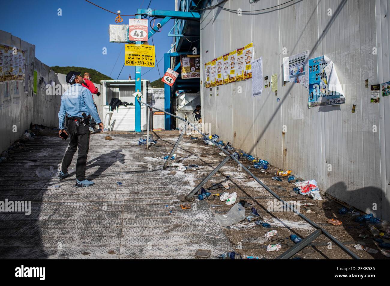 Mont Meron, Israël. 30 avril 2021. Un policier israélien inspecte le site où des personnes sont mortes lors d'une panique de masse sur une rampe métallique flanquée de murs métalliques, sur le site de pèlerinage juif orthodoxe du Mont Meron. Des dizaines de fidèles ont été tués dans une bousculade vendredi, au cours du festival religieux juif de Lag Ba'Omer, dans le nord d'Israël. Crédit : Ilia Yefimovich/dpa/Alay Live News Banque D'Images