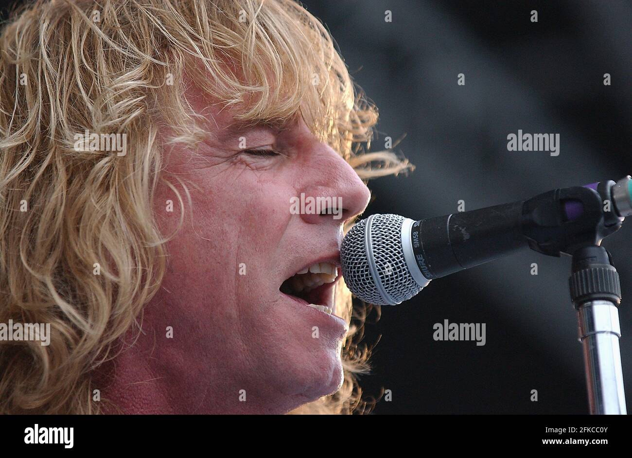 RICK PARFITT I DE STATUS QUO SUR SCÈNE À BORD DU HMS ARK ROYAL À PORTSMOUTH OÙ LE GROUPE S'EST PRODUIT POUR QUE L'ÉQUIPAGE LANCE SON NOUVEL ALBUM. PIC MIKE WALKER, 2002 Banque D'Images