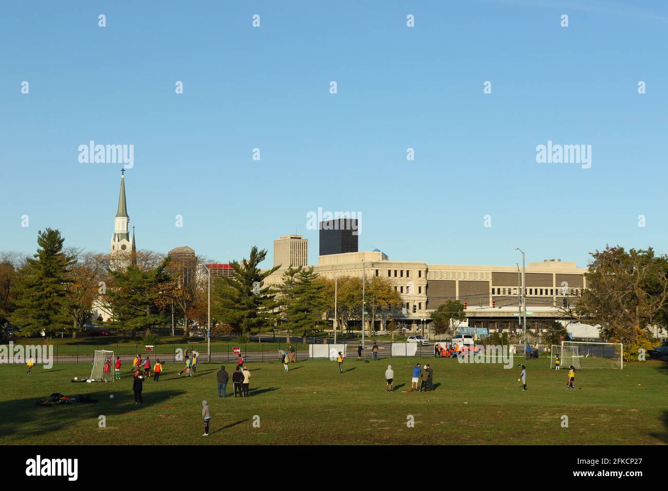 Les jeunes pratiquent le football devant un horizon de la ville de Dayton. Bomberger Park, Dayton, Ohio, États-Unis. Banque D'Images