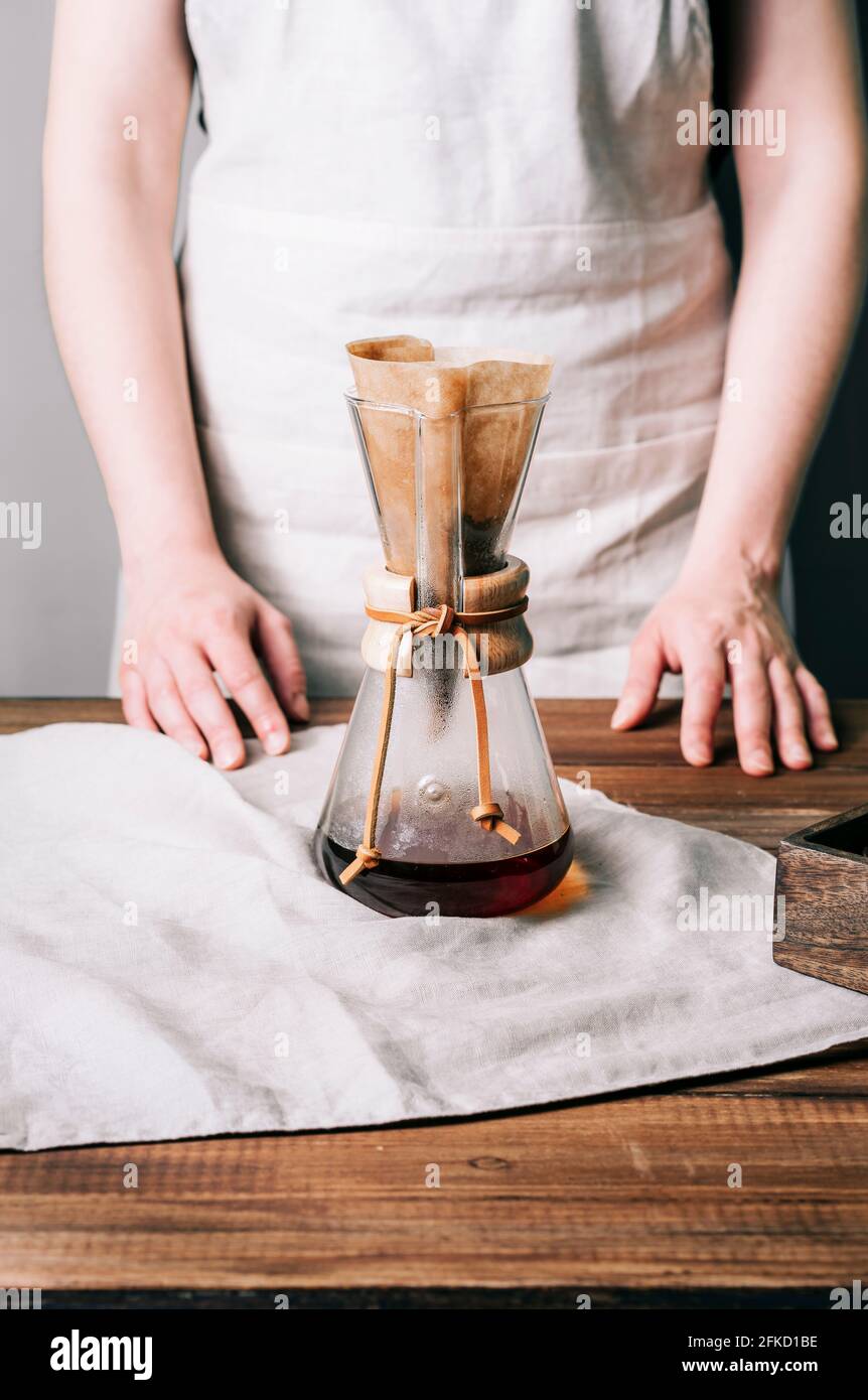 Vue fermée d'une cafetière manuelle en verre avec filtre et café  fraîchement préparé à l'intérieur sur une table en bois Photo Stock - Alamy