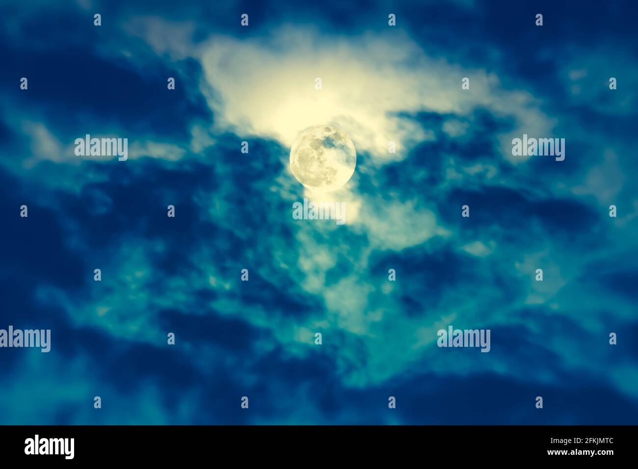 Arrière-plan du ciel nocturne avec nuage et pleine lune avec brillant. Beauté naturelle la nuit avec une magnifique lune derrière le nuage. Processus croisé et vintage Banque D'Images