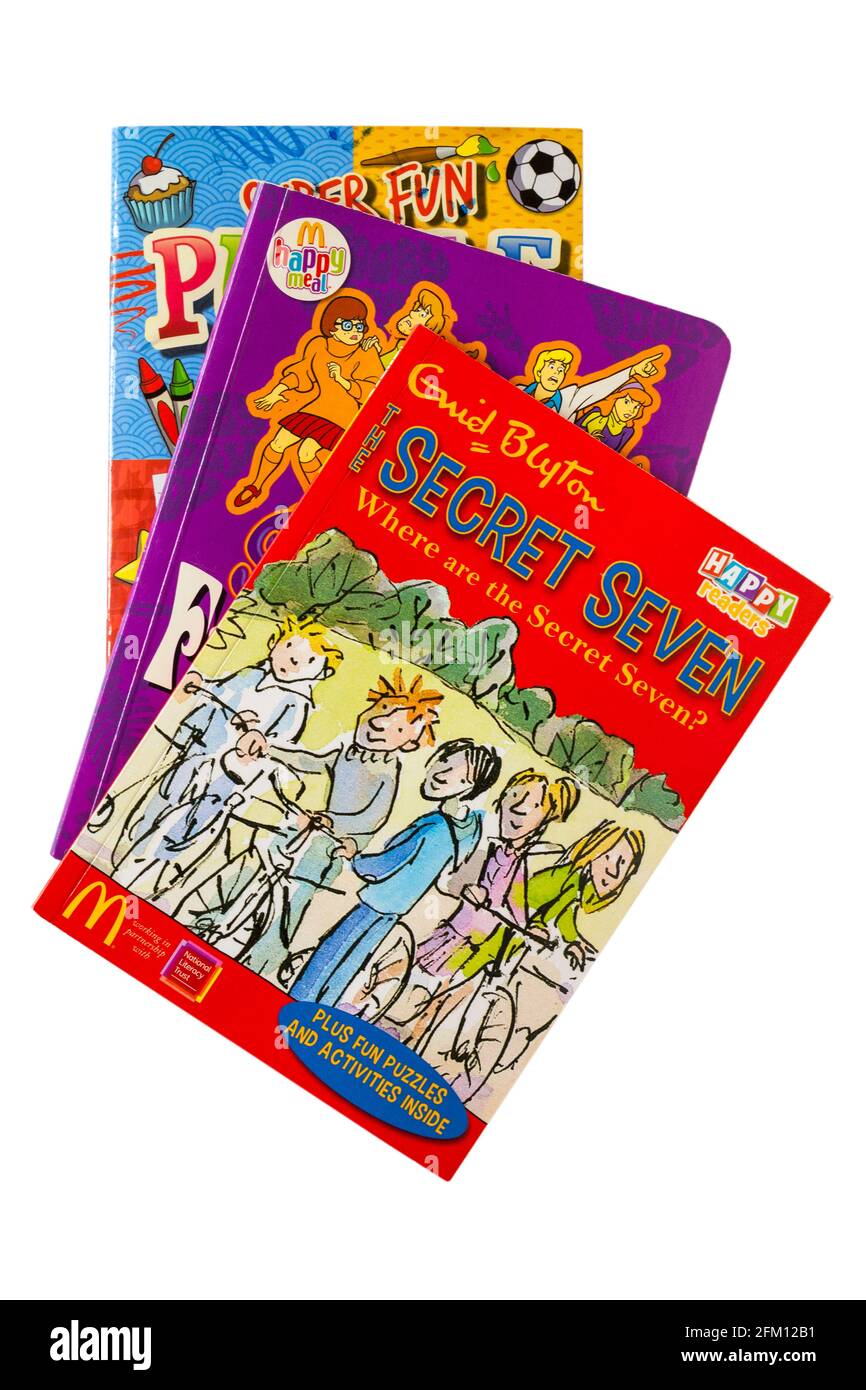 Pile de livres pour enfants avec Enid Blyton Secret Seven livre En haut, isolé sur fond blanc - McDonalds Happy Meal livre Banque D'Images