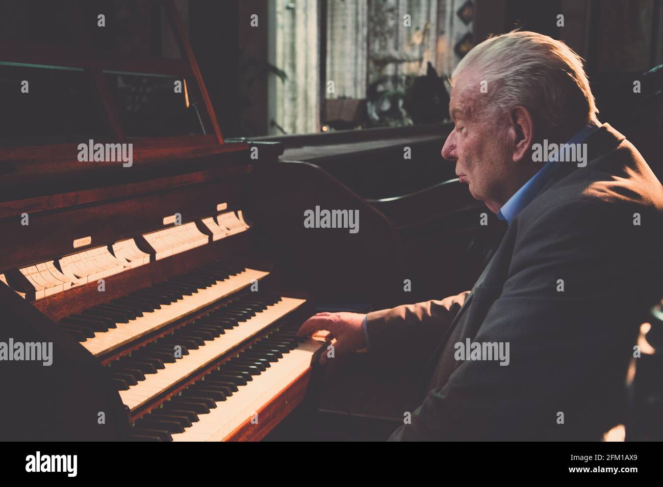 Vieil homme jouant de l'orgue dans l'Église Banque D'Images