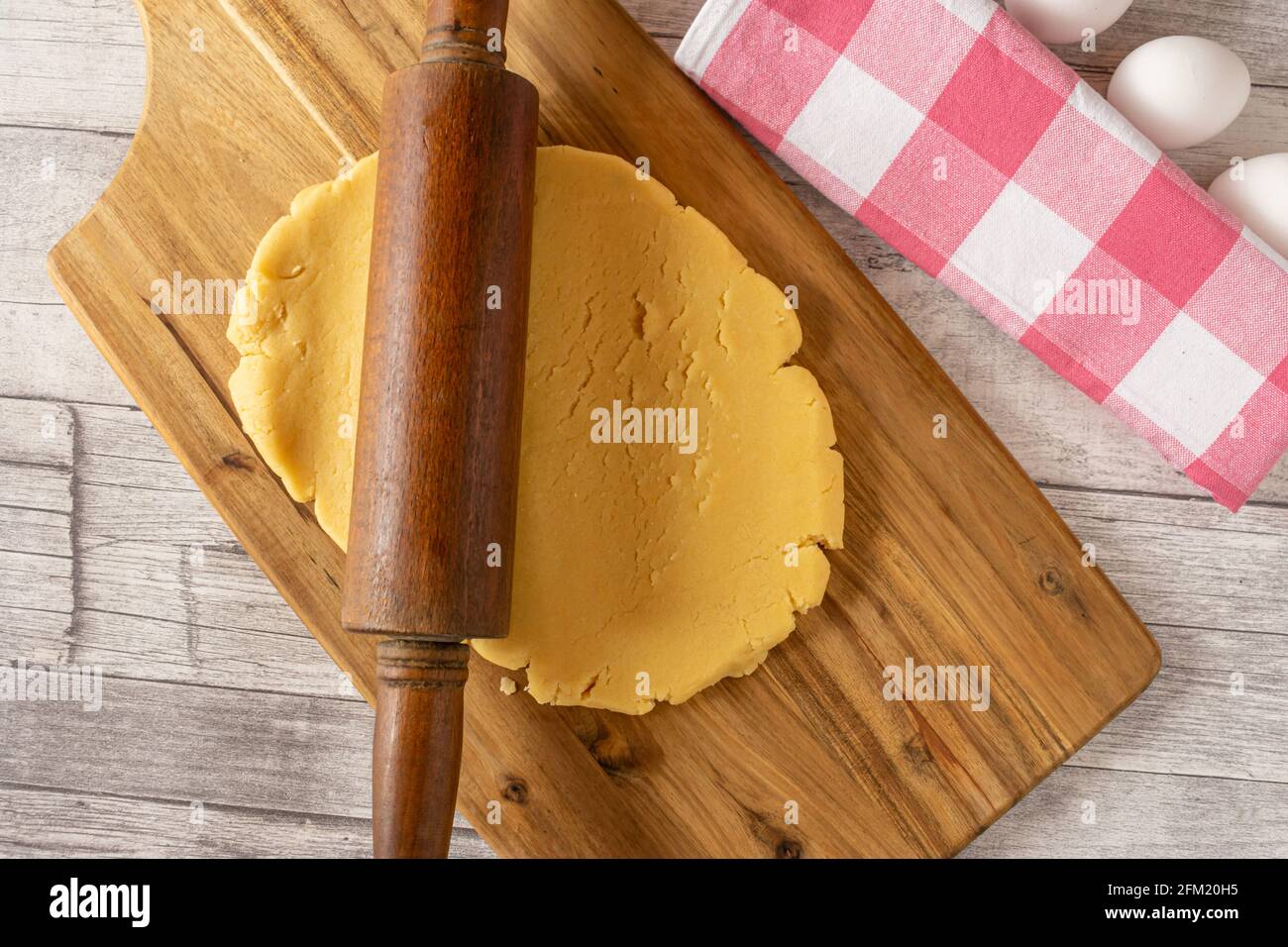 pâte à gâteau roulé sur une planche de bois avec laminage broche Banque D'Images