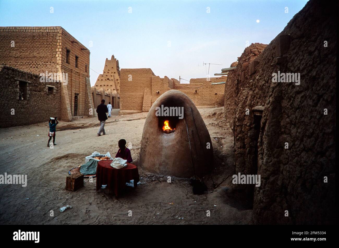 Four à pain sur une route menant à la mosquée de Sankore dans la soirée. Un garçon vend le pain fraîchement cuit aux passants. 19.11.2003 - Christoph Keller Banque D'Images