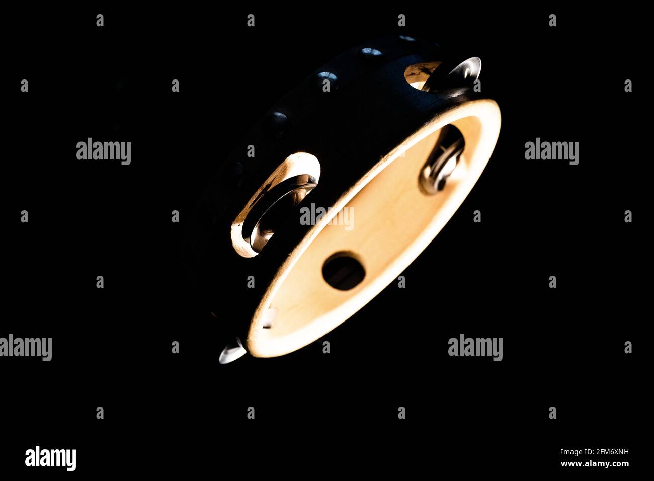 Tambourine isolée à contraste élevé sur fond noir Banque D'Images