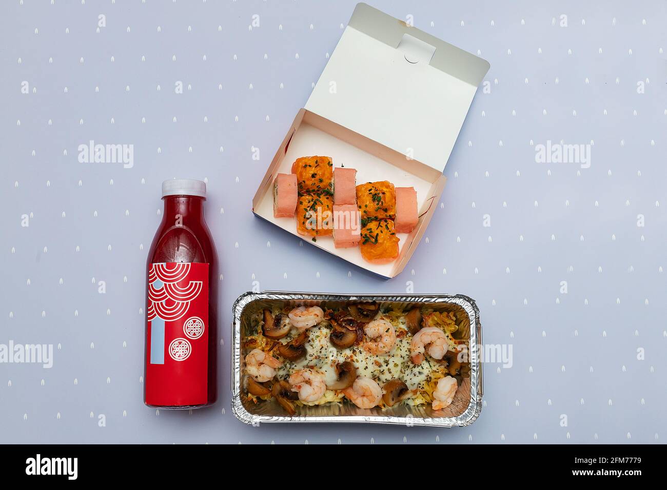 des boîtes ouvertes avec des petits pains à sushis et une bouteille de jus frais, des emballages de livraison de nourriture en matériaux écologiques, de magnifiques vaisselle jetables dans bri Banque D'Images