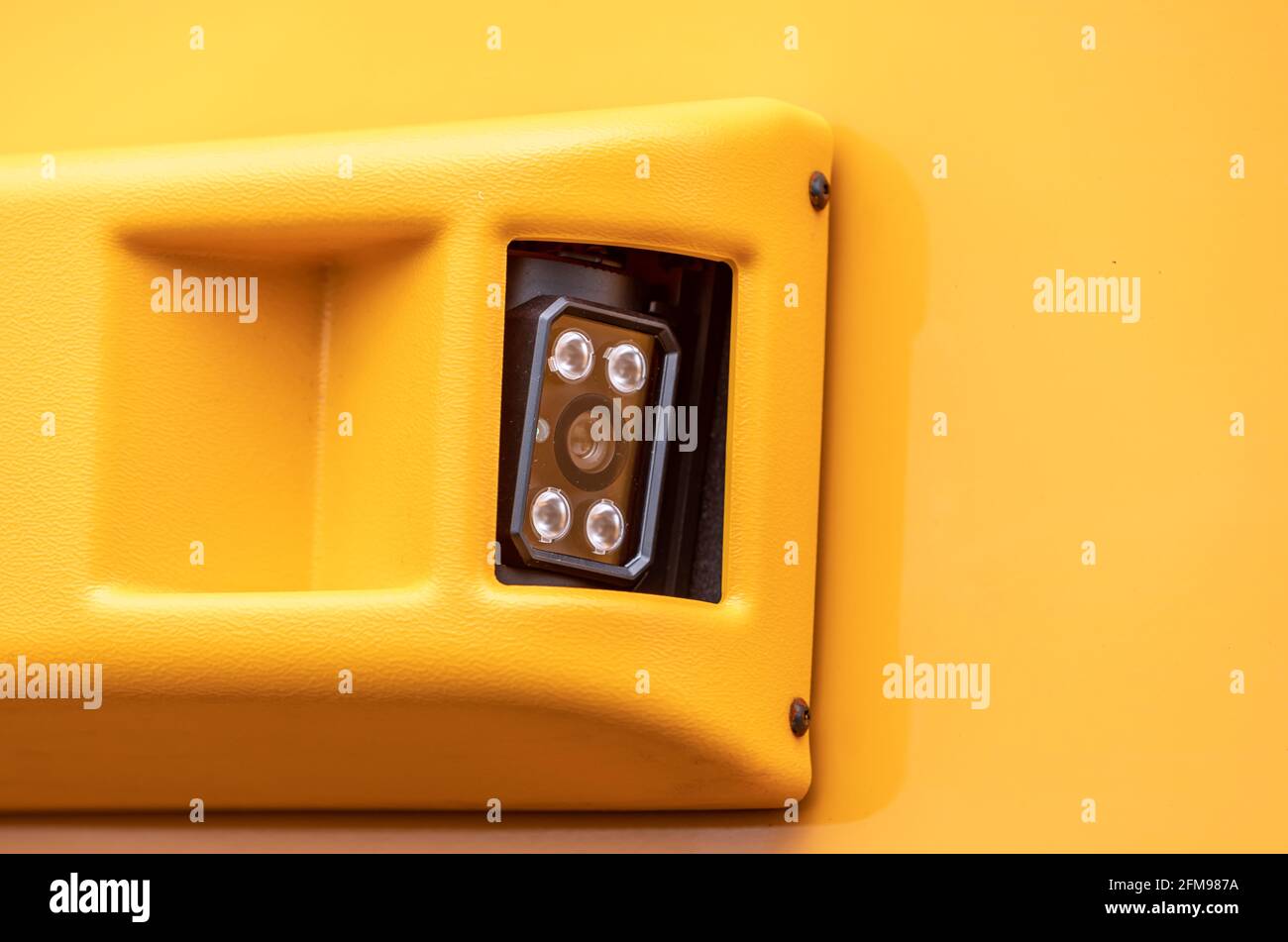 Image détaillée d'une caméra montée sur le côté de un bus scolaire jaune Banque D'Images