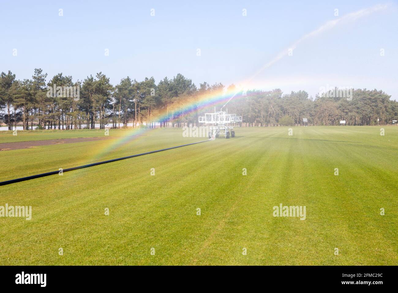 Machine d'irrigation pour la pulvérisation d'eau sur gazon, Sutton Heath, Suffolk, Angleterre, Royaume-Uni Banque D'Images
