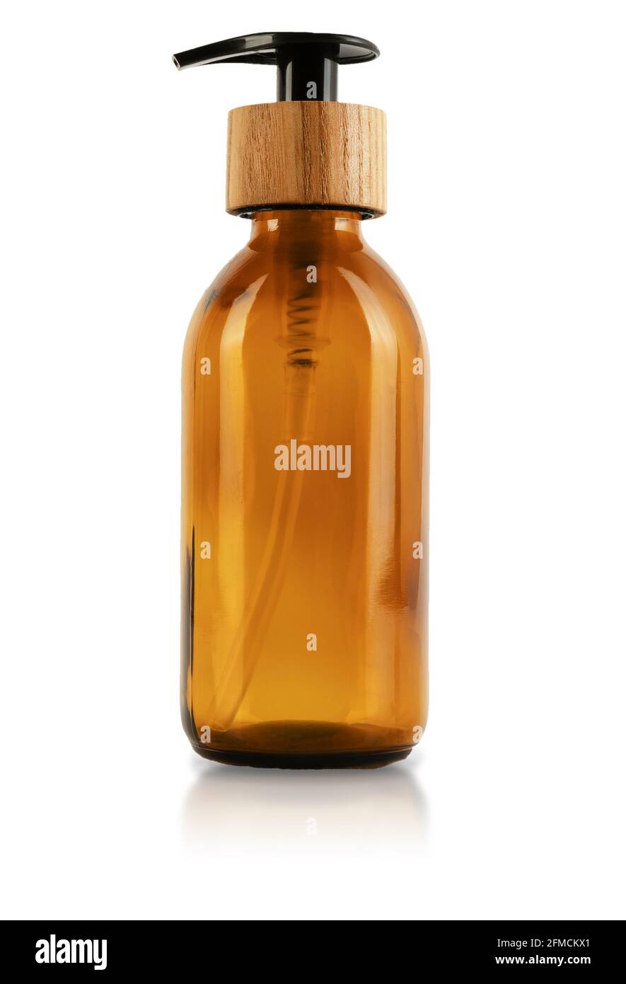 Flacon en verre brun avec distributeur et bouchon en bois.Isolé sur fond blanc.Contenant écologique pour cosmétiques.Un récipient avec une paille à l'intérieur et un bouton pour une pompe pour le gel, la lotion ou le shampooing. Banque D'Images