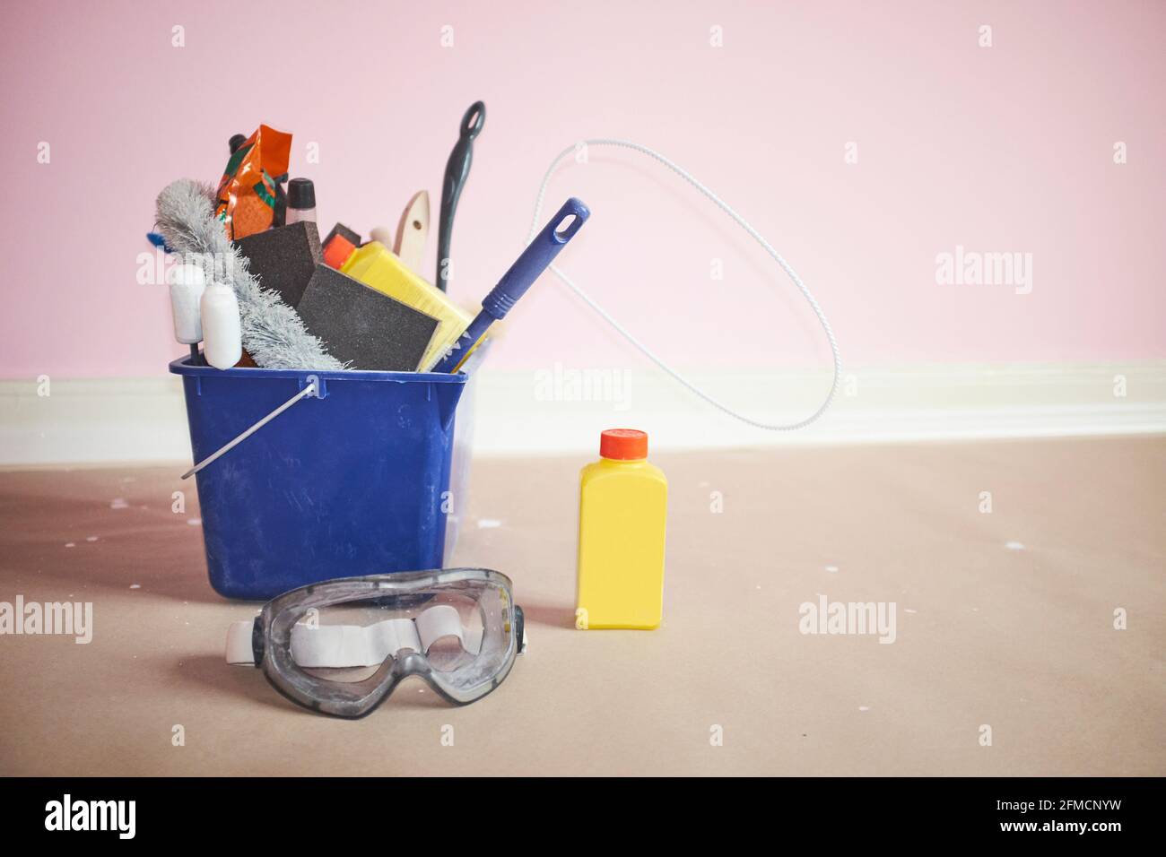 Seau bleu rempli d'outils et de substances de nettoyage et de redécoration avec lunettes Banque D'Images