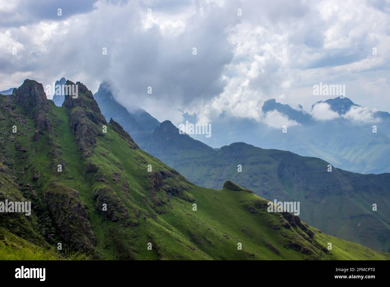 Le pic de Cleft, l'une des montagnes du Drakensberg en Afrique du Sud, avec d'autres pics de basalte entourés de nuages en arrière-plan Banque D'Images