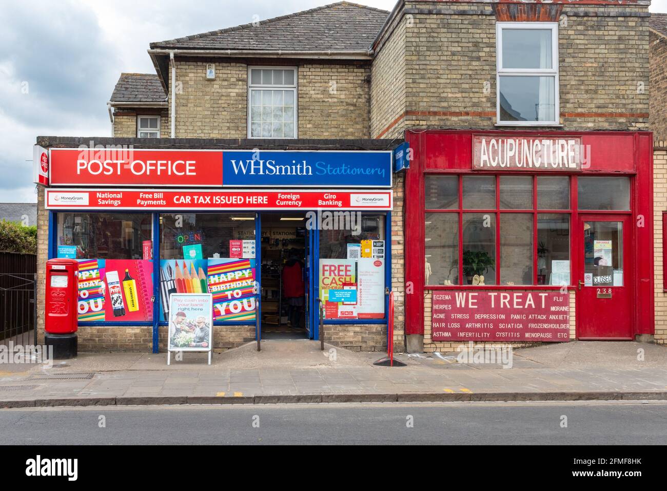 Vue extérieure du bureau de poste sur Mill Road, à côté d'un magasin de médecine chinoise et d'acupuncture. Cambridge, Royaume-Uni Banque D'Images