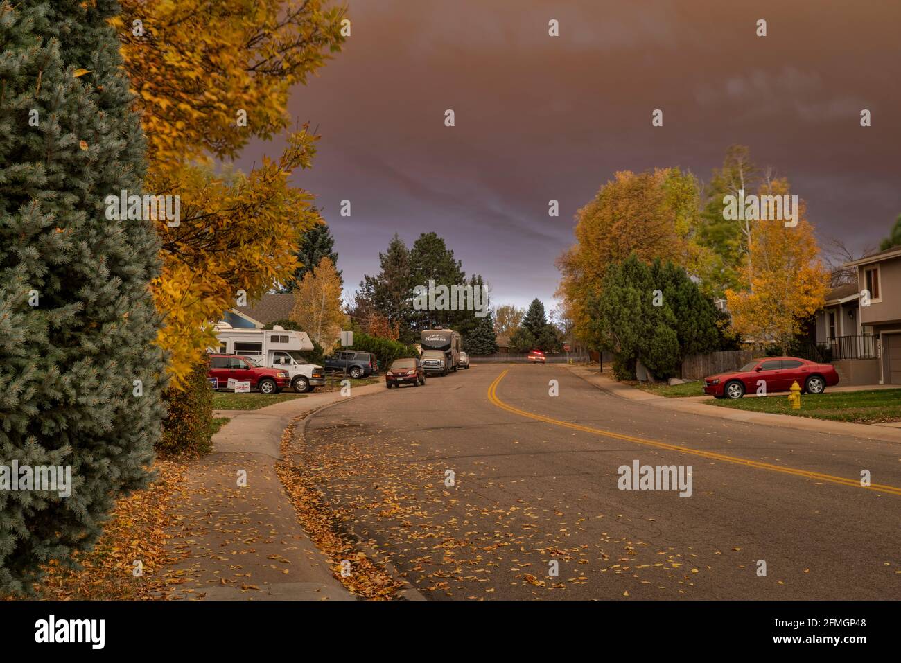 Fort Collins, Colorado, États-Unis - 22 octobre 2020 : vue à mi-journée d'une rue résidentielle sous un fort panache de fumée provenant d'un feu de forêt montagneuse - laisse malsaine Banque D'Images