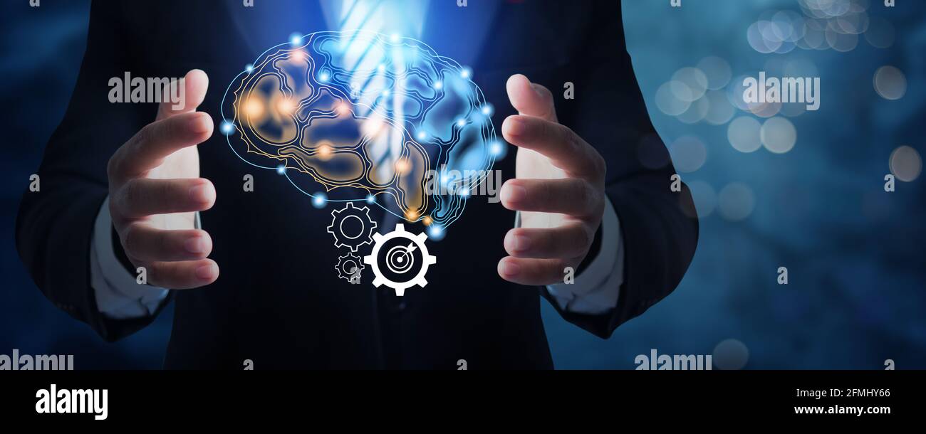 Homme d'affaires en costume tenant l'icône de connexion de cerveau actif et idée travailler et planifier le concept Banque D'Images