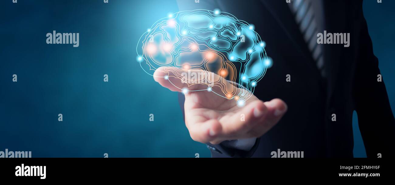Homme d'affaires en costume tenant l'icône de connexion de cerveau actif et idée travailler et planifier le concept Banque D'Images