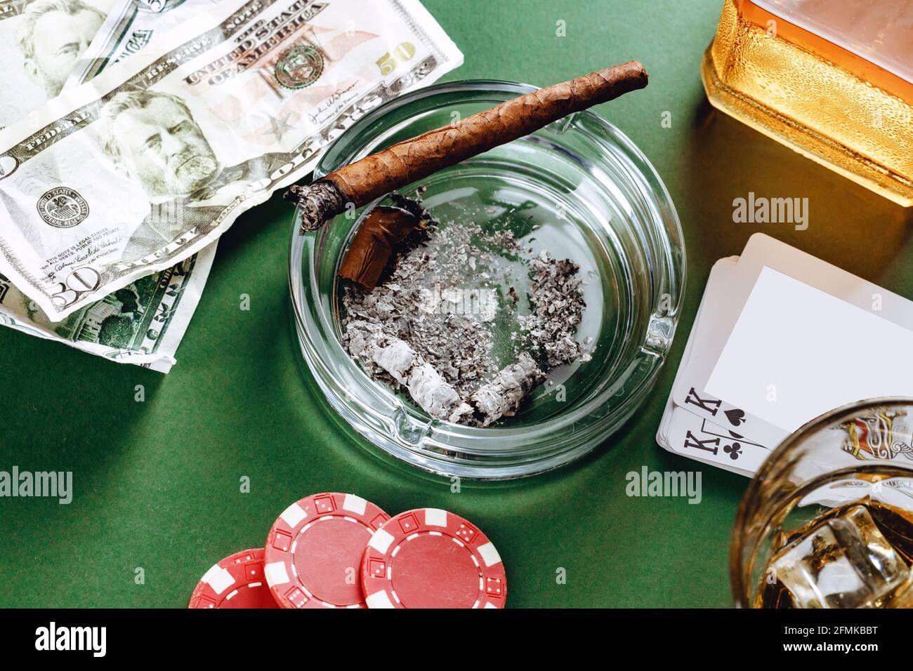 Cigare cubain et argent sur fond vert Banque D'Images