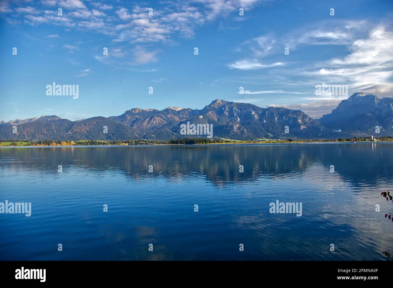 Vue imprenable sur les montagnes rocheuses qui se reflète sur un lac Forggensee en miroir à Allgau, en Allemagne Banque D'Images