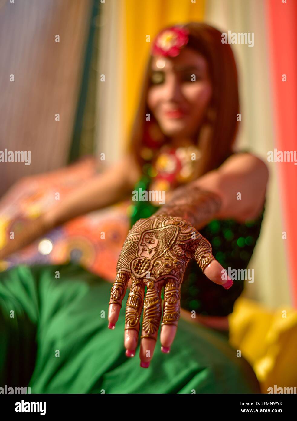 portrait d'une mariée indienne stupéfiante, appliquant hinna sur son mariage. Banque D'Images
