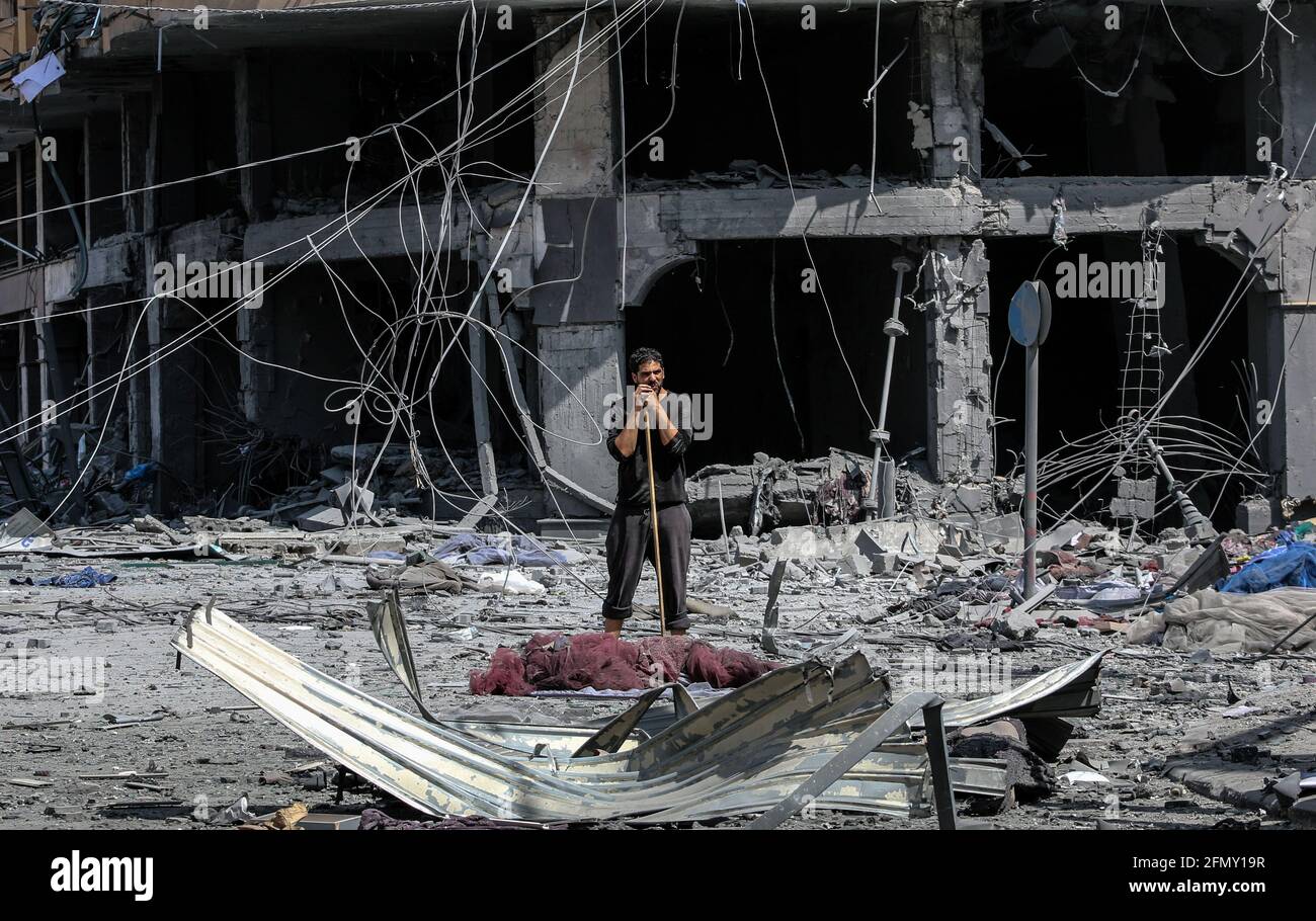 Gaza, Palestine. 12 mai 2021. Un palestinien se tient parmi les décombres de la tour Al-Jawhara, gravement endommagée, dans la ville de Gaza, après avoir été frappé par des frappes aériennes israéliennes dans le contexte de l'escalade de la violence israélo-palestinienne. Le ministère de la Santé de la bande de Gaza, dirigée par le Hamas, a déclaré que le nombre de Palestiniens tués était passé à 35, dont 12 enfants, et 233 personnes ont été blessées. (Photo par Ahmed Zakot/SOPA Images/Sipa USA) crédit: SIPA USA/Alay Live News Banque D'Images
