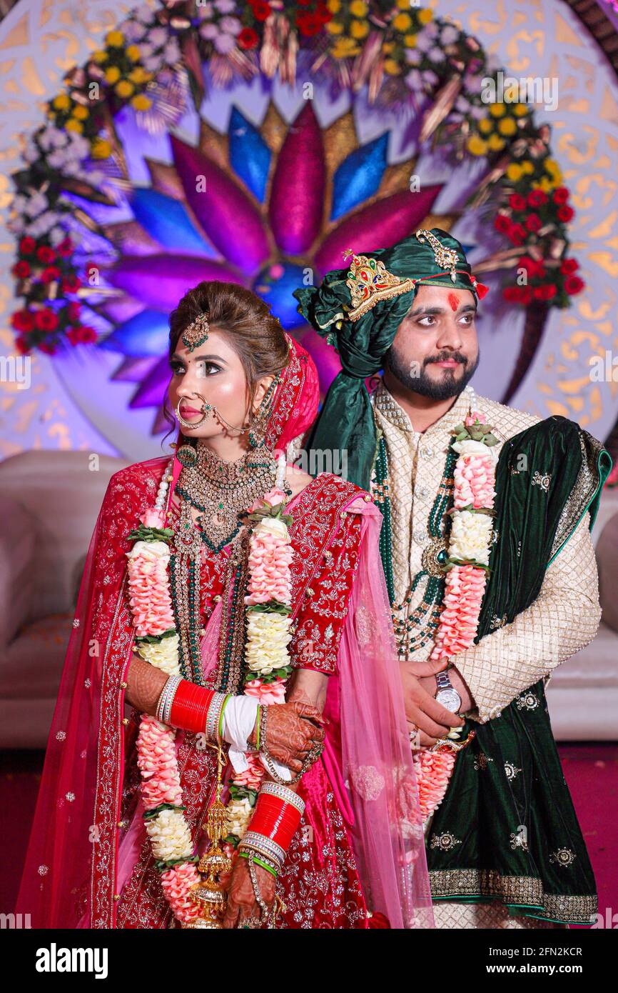magnifique superbe mariée indienne et robe traditionnelle de marié posent sur leur cérémonie de mariage. Banque D'Images